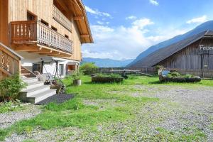 a building with a porch and stairs next to a barn at Felderhof in Villa Ottone