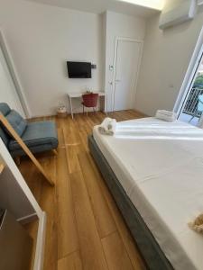 a bedroom with a large bed and a television at B&B Magnolie in Palermo