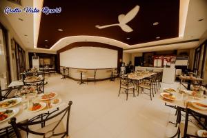 a restaurant with tables and chairs with food on them at Grotto Vista Resort in San Jose del Monte +4 photos