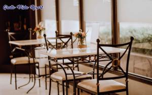 a group of tables and chairs with flowers on them at Grotto Vista Resort in San Jose del Monte