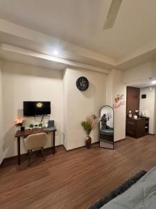 a living room with a desk and a mirror at Arya homestay in Greater Noida