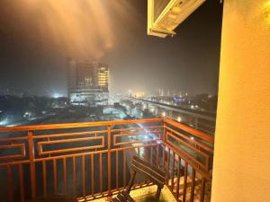a view of a city at night from a balcony at Arya homestay in Greater Noida