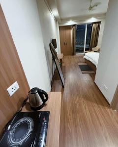 a room with a bed and a desk with a radio at Arya homestay in Greater Noida