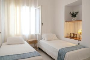 a bedroom with two beds and a window at Lydía Residence - Mantoudi Evia in Mantoúdion