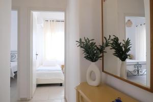 a bathroom with a mirror and a bedroom with a bed at Lydía Residence - Mantoudi Evia in Mantoúdion +8 photos