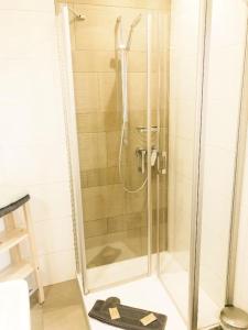 a shower with a glass door in a bathroom at Gästehaus Mönchshof in Sommerhausen +15 photos