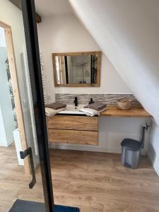 a bathroom with a sink and a mirror at La clé du Temps in Falaise