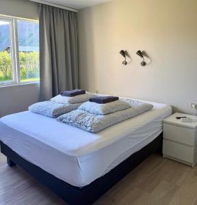 a bedroom with a bed with two towels on it at Bjarkarholt Guesthouse in Bjarkarholt