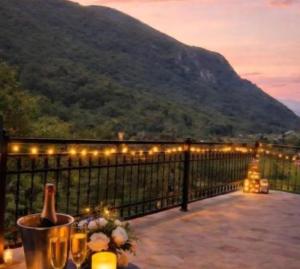 a balcony with a table with candles and lights at Vila Lenka in Rtanj