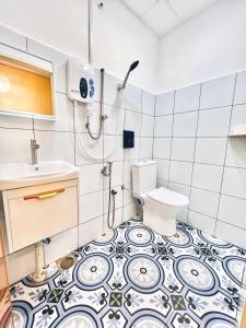 a bathroom with a toilet and a sink at Camp Fire Homestay 2601 in Mersing +20 photos