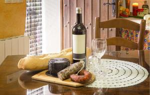 a bottle of wine and some food on a table at El Museo in Laroya