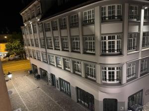 a white building with many windows and a street at City Center big Appartement in St. Gallen