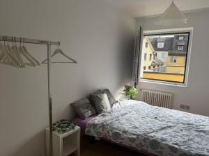a bedroom with a bed and a window at City Center big Appartement in St. Gallen