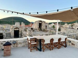 a table and chairs under a tent on a patio at Patossa in Chios