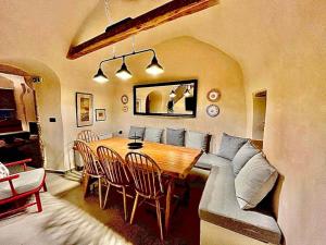 a living room with a table and a couch at Patossa in Chios