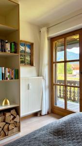 a bedroom with a book shelf and a window at FeWo Rottachglück in Tegernsee