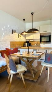 a kitchen with a table and chairs in a room at FeWo Rottachglück in Tegernsee