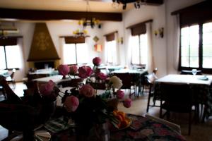 una habitación con mesas y flores en una mesa en Hotel Bon Lloc en Ulldecona