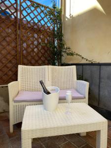 a table with a bottle and a glass on a chair at Carla's studio in Pompei
