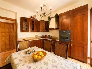 a kitchen with a table with a bowl of fruit on it at La Casita Del Mar in San Vito lo Capo +2 photos