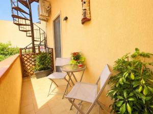 a small balcony with a table and chairs on a building at La Casita Del Mar in San Vito lo Capo