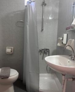 a bathroom with a shower and a toilet and a sink at Ermis Suites in Platanias +50 photos