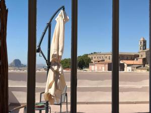 a room with a chair and a window with a view at Casa Manzoni- Appartamento con terrazzo in centro in Mussomeli