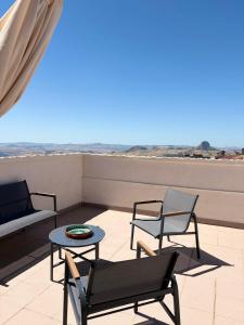 a patio with two chairs and a table on a roof at Casa Manzoni- Appartamento con terrazzo in centro in Mussomeli