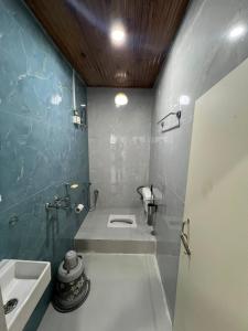 a bathroom with a sink and a toilet in it at Home away homestay in Namchi