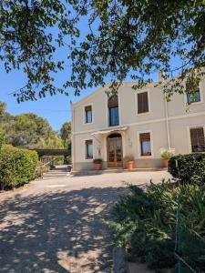 a large white house with a driveway at Mas Palou in Pla del Panadés