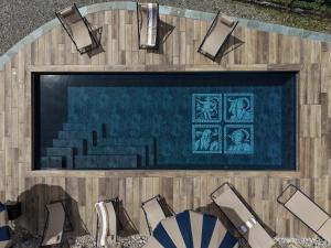 an overhead view of a swimming pool with chairs at Villa Jolanda, a Garamonds Property in Brunate