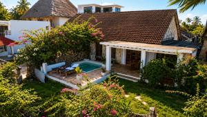 a house with a swimming pool in the yard at Malcom Ocean View Retreat in Pongwe