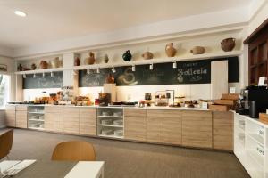 a kitchen with wooden cabinets and vases on the shelves at Sercotel Puerto de Santa María in El Puerto de Santa María