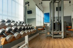 a room with a bunch of dumbbells on a wall at Sercotel Puerto de Santa María in El Puerto de Santa María