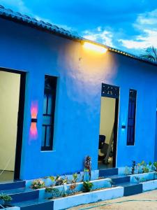 a blue house with some plants in front of it at HELLO MADHi VILLA in Arugam Bay