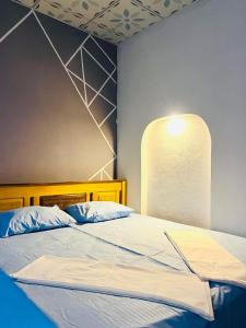 a bedroom with a large bed with blue walls at HELLO MADHi VILLA in Arugam Bay