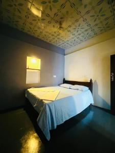 a bedroom with a large bed in a room at HELLO MADHi VILLA in Arugam Bay