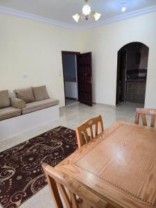 a living room with a wooden table and a couch at Spazio Undici 11 in Marsa Matruh
