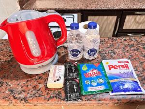 a counter with two bottles of water and a kettle at Spazio Undici 11 in Marsa Matruh