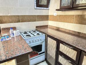 a kitchen with a stove and a counter top at Spazio Undici 11 in Marsa Matruh +9 photos