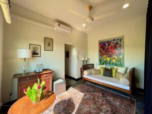 a living room with a couch and a table at Rumah Cermin in Langkawi Intl +10 photos