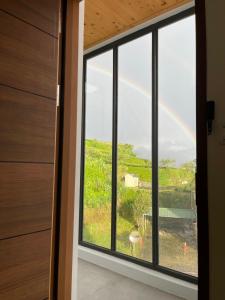 a rainbow seen through a window in a house at Shan Da Ke Qi Min Su in Zhonghe +6 photos