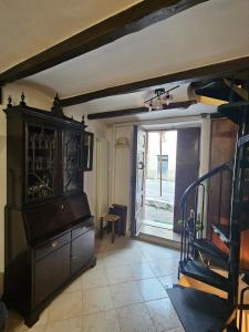 a living room with a staircase and a piano at Casina Giulia in Capistrello