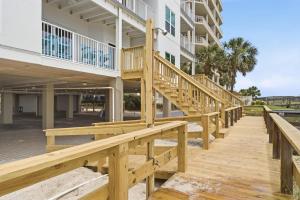 a wooden boardwalk leading up to a building at Riviera Dunes 503 in Perdido Key