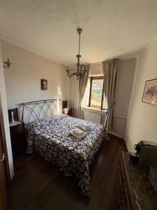 a bedroom with a bed with a comforter on it at Casina Giulia in Capistrello