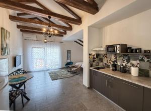 a kitchen with a counter and a table in a room at Seaside Village in Kamenari