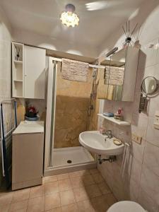 a small bathroom with a sink and a shower at Casina Giulia in Capistrello +16 photos