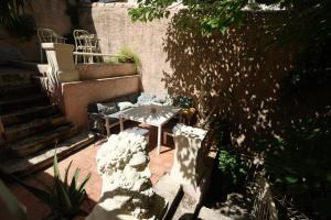 a small patio with a table and a staircase at Boutique Hôtel Azur in Marseille