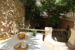 a picnic table with a bowl of fruit on it at Boutique Hôtel Azur in Marseille