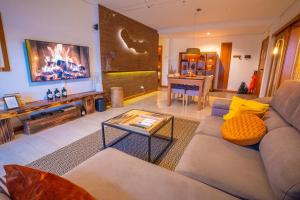a living room with a couch and a table at epicenter SANTACRUZ in Lagoa